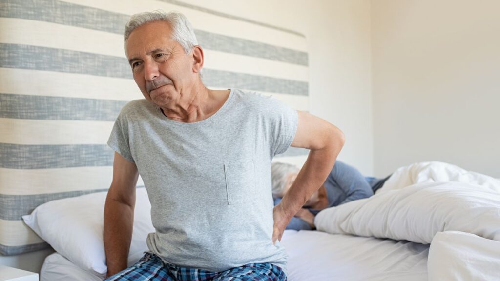 Elderly man suffering back pain
