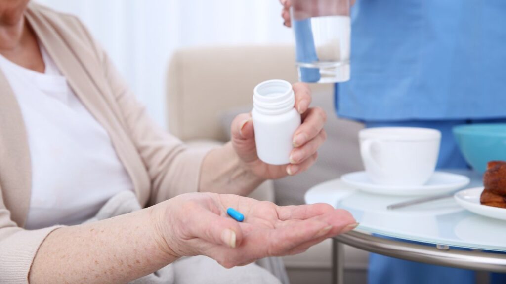 Elderly woman taking pills