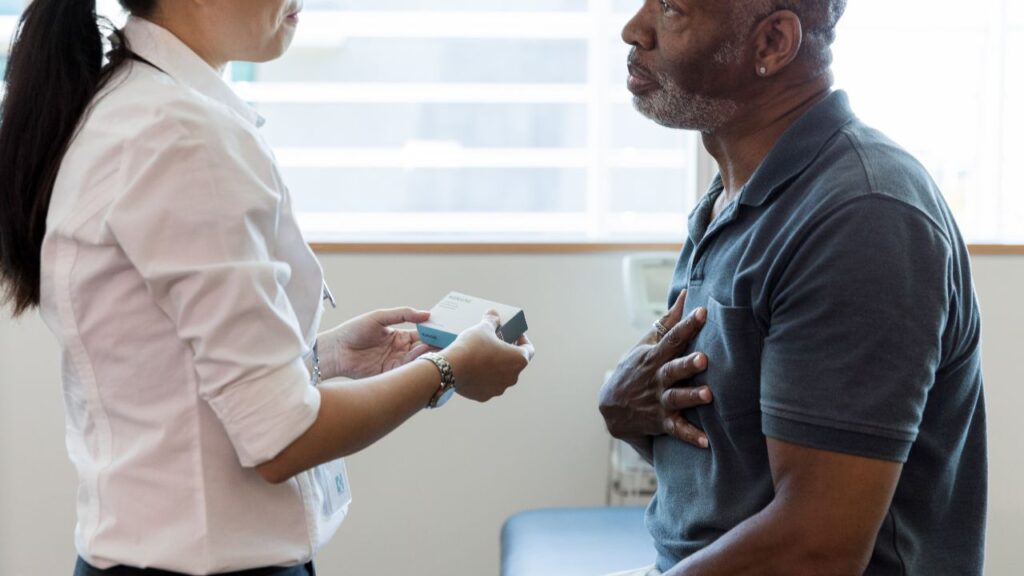 Female doctor and senior male discussing prescription drug