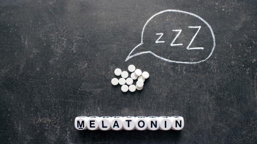 Melatonin sleeping pills on a chalk board background