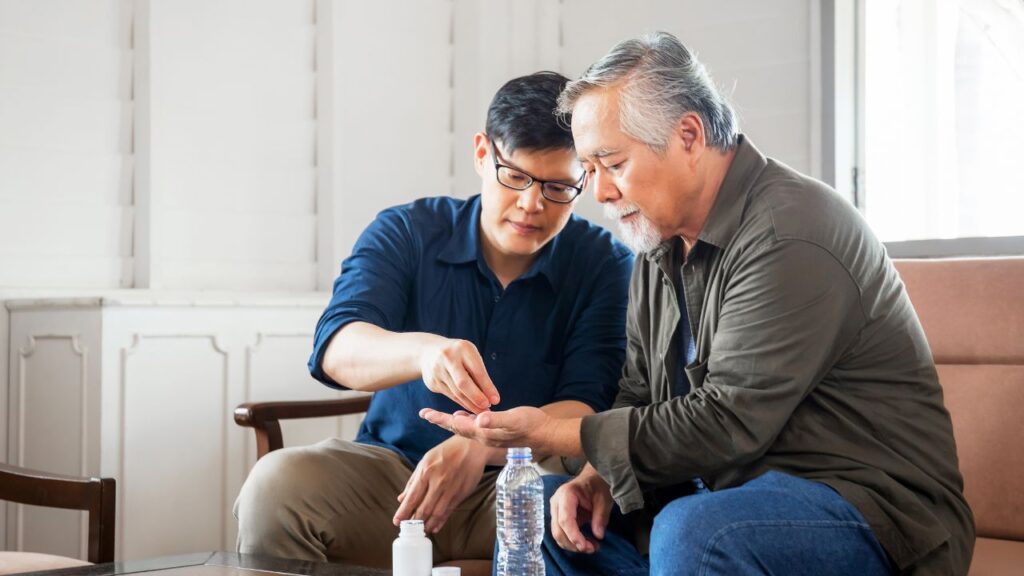 Middle aged son takes care of sick senior father