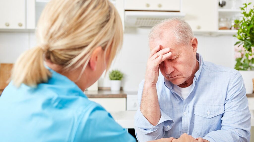 Nurse comfort senior man with dementia