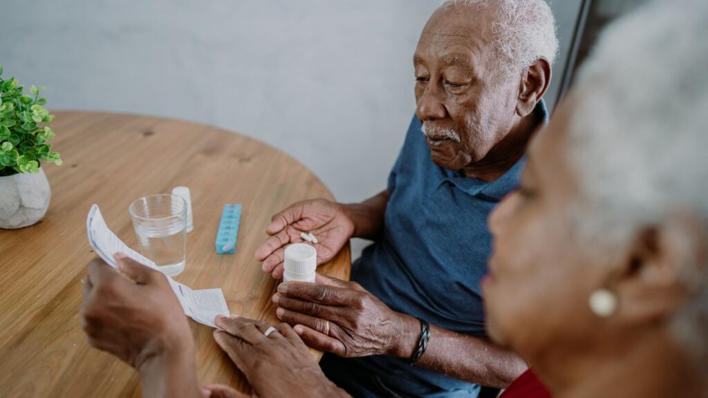 Senior couple taking medication at home