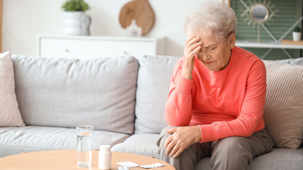Sick senior woman with pills