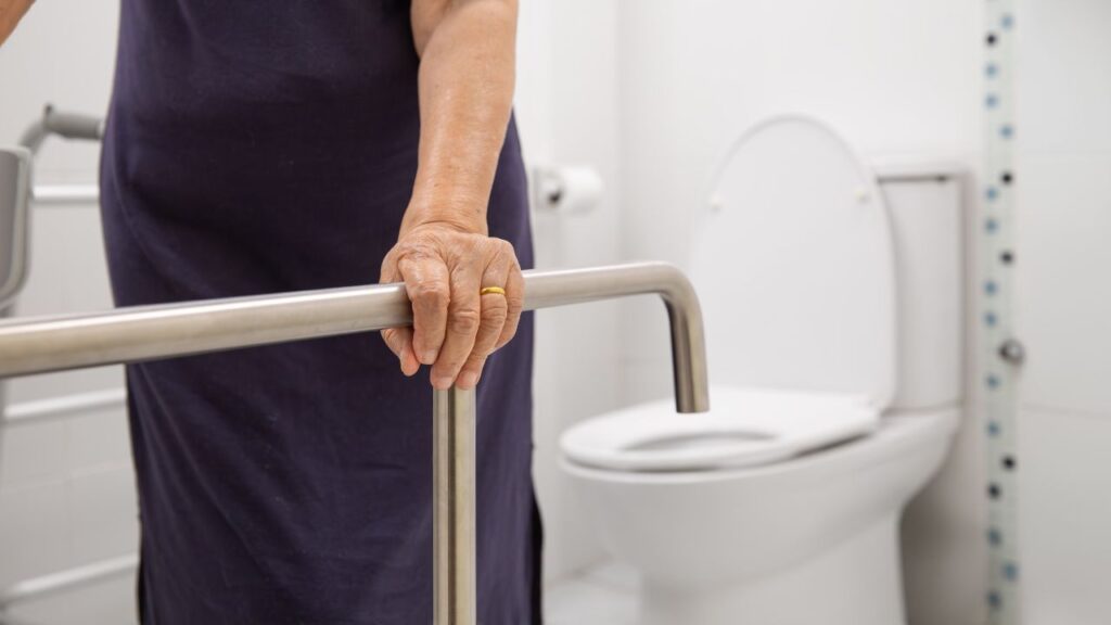 Elderly Woman Using Bathroom Safety Rail
