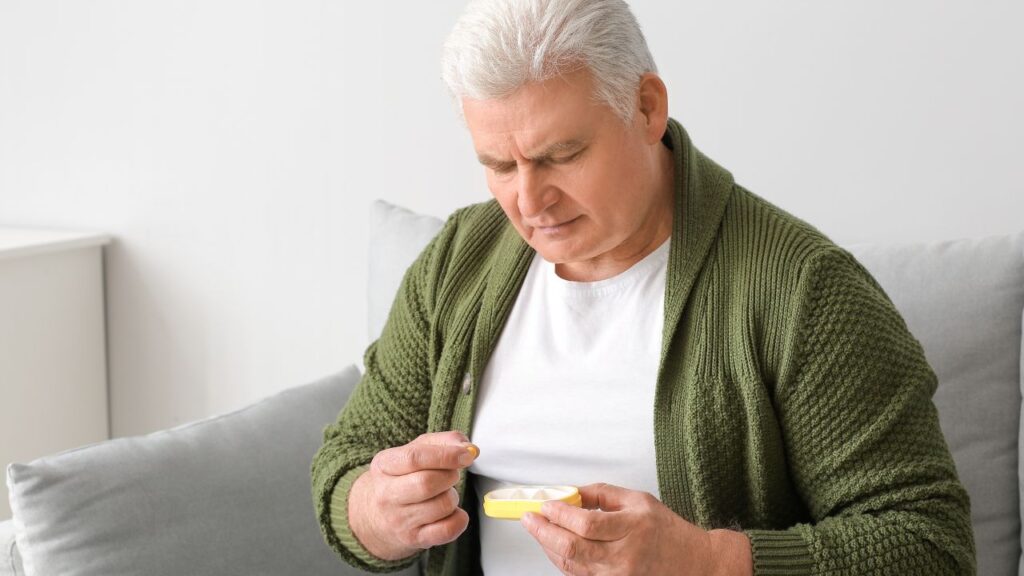 Senior Man Taking Pills at Home